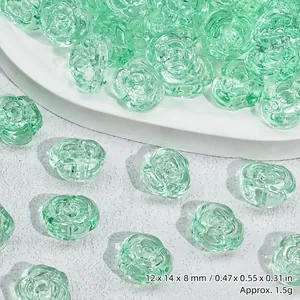 Close-up detail of light green translucent rose-shaped glass beads for jewelry