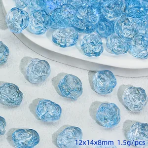 Detailed view of light blue rose-shaped glass beads with embossed flower petals