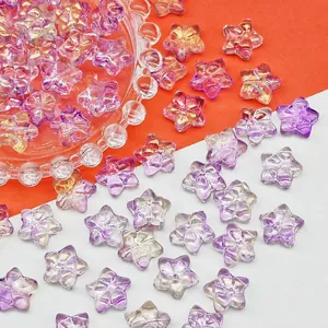 Close-up of iridescent star-shaped glass beads with bow design for DIY jewelry making.