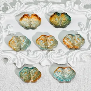 Detail of Ruyi auspicious cloud glass beads for DIY jewelry making, size 9x13x4mm