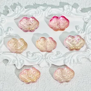 Macro view of Ruyi cloud glass beads in pink and gold gradient for handmade jewelry DIY