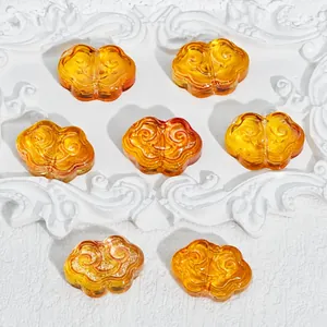 Detailed view of amber translucent colored glaze auspicious cloud beads for DIY jewelry