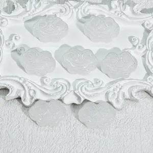 Close-up detail of small RuYi cloud shaped glass pendants for DIY jewelry making