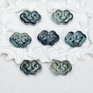 Macro view of Ruyi Auspicious Cloud shape glazed glass beads for DIY jewelry making