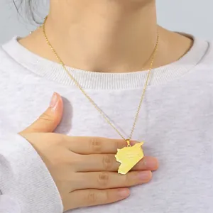 Detail of gold stainless steel Syria map pendant necklace shown on a model's neck.