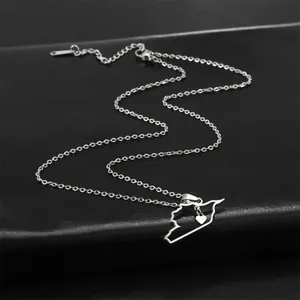 Detailed view of Syria map outline necklace with small heart charm in silver finish