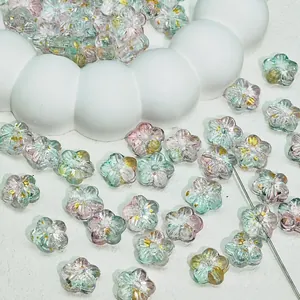 Detail view of gradient cherry blossom glass beads with gold foil for DIY jewelry