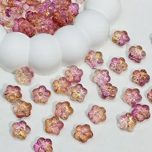 Close-up detail of gradient purple and pink Sakura flower glass beads for DIY jewelry making