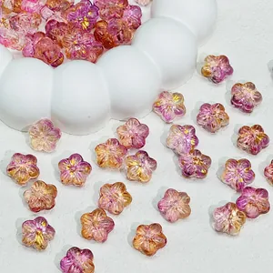 Close-up detail of gradient purple and pink Sakura flower glass beads for DIY jewelry making