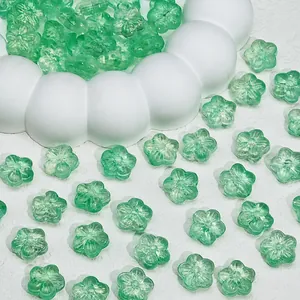Macro view of translucent green cherry blossom glass beads for DIY jewelry accessories