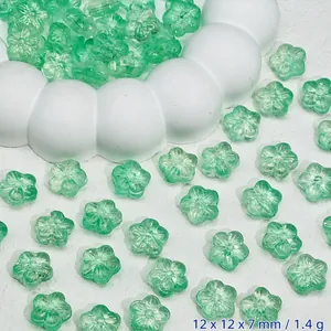 Macro view of translucent green cherry blossom glass beads for DIY jewelry accessories