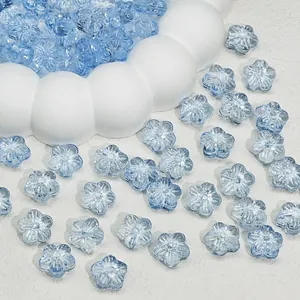 Close-up of translucent light blue cherry blossom glass beads for DIY jewelry making.