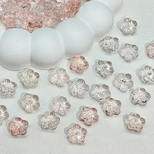 Macro view of transparent pink gradient cherry blossom glass beads for DIY jewelry making