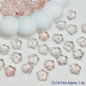 Macro view of transparent pink gradient cherry blossom glass beads for DIY jewelry making