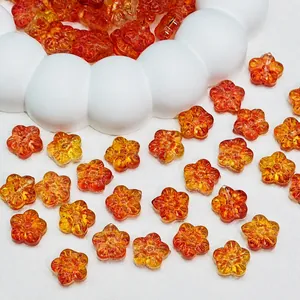 Close-up of gradient orange glass sakura beads measuring 12x12x7mm