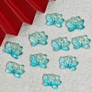 Close-up macro view of light blue lotus-shaped glass beads for DIY jewelry craft making