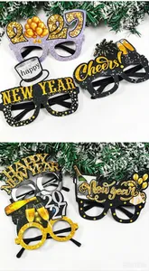 Detailed view of 2027 New Year glitter glasses with festive slogans and champagne motifs.