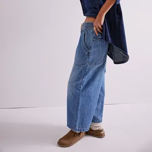 Close-up of women's straight-leg washed denim jeans with elastic waist and side pockets