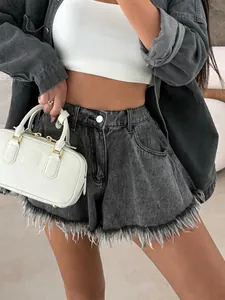 Close-up detail of stylish high waisted black denim umbrella shorts with frayed hem