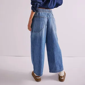 Back view of women's washed blue denim wide-leg cropped pants with elastic waist