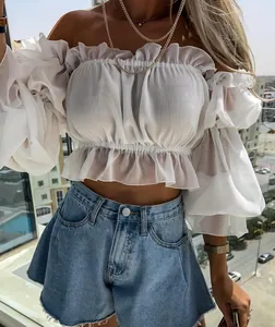 Trendy high-waisted umbrella-shaped denim shorts with raw hem styled with a white top