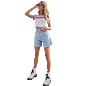 High-waisted loose denim shorts with raw hem for a trendy western casual street style look.