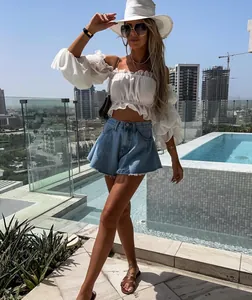 Fashionable high-waisted umbrella-style denim shorts with raw hem in light blue wash