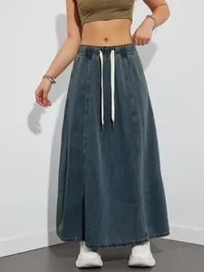 Fashionable detail of a vintage wash denim maxi skirt with an elastic drawstring waist