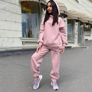 Detail view of a cozy pink oversized hooded sweatshirt and jogger pants set for women.