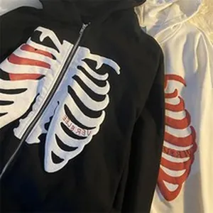 Detail shot of skeleton ribcage zip-up hoodie with heart print in black and white colors.