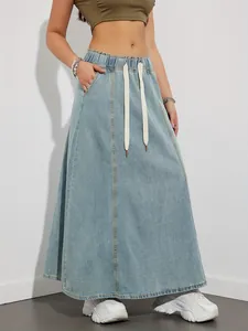 Stylish women's light blue denim maxi skirt featuring a comfortable drawstring waist