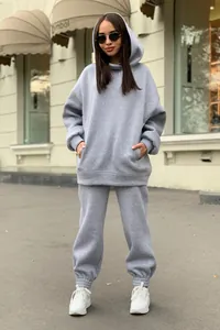 Stylish grey oversized hooded tracksuit set with fleece-lined hoodie and matching joggers.