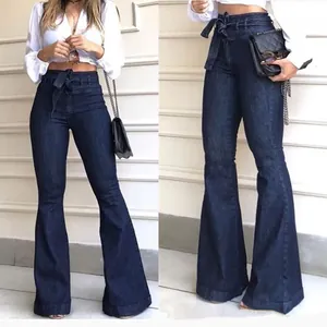 Detailed view of high waisted dark blue flared denim jeans with tie waist belt