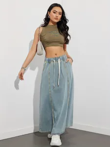 Full-length view of light blue denim skirt with elastic drawstring waist and flowy design