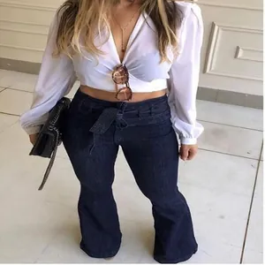 Full view of women's high-waisted flared jeans with a stylish tie belt.