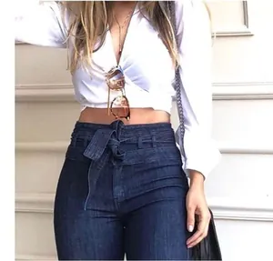 Detailed view of high-waisted flare jeans with a decorative tie-belt at the waist.