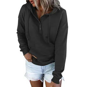 Detail of black long sleeve hooded sweatshirt featuring button-up neckline and drawstring.
