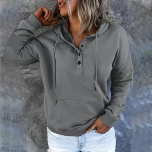 Detail of women's grey casual hoodie featuring button neck and front pocket