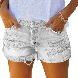 Detail of gray distressed denim shorts with multiple button fly and frayed fringe