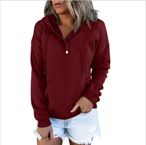 Close-up of a maroon women's long-sleeved hooded sweatshirt with button neckline detail