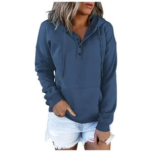 Detailed view of women's loose casual blue hoodie featuring drawstring and buttoned neckline