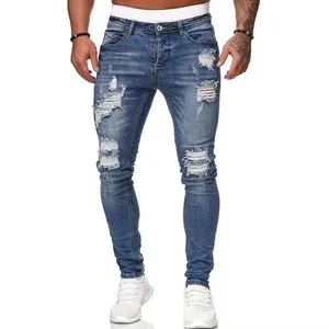 Close-up view of men's slim-fit distressed blue jeans with stylish ripped details.