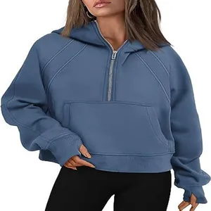 Detailed view of women's blue half-zip cropped fleece hoodie with front kangaroo pocket