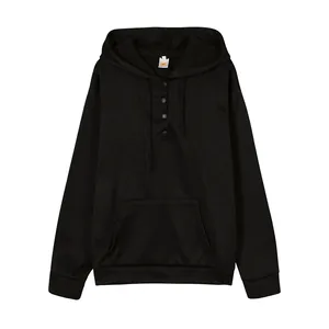 Detail view of a black hooded sweatshirt with button placket and kangaroo pocket.