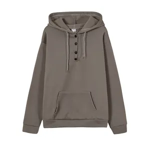 Detail view of a loose casual hooded sweatshirt with drawstring and button neckline