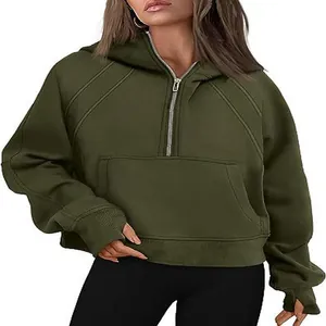 Close-up of women's cropped half-zip hoodie with fleece lining and thumbholes