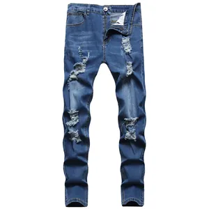 Detail view of men's distressed blue denim jeans with heavy ripped and faded accents.