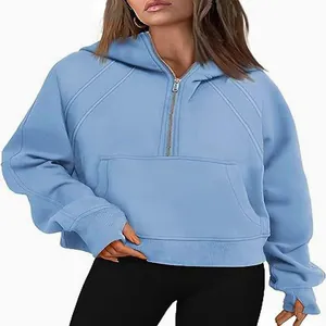 Close-up of light blue half-zip hooded sweatshirt featuring thumbhole cuffs and pocket