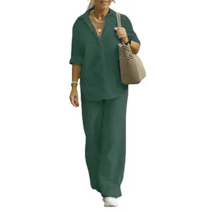 Full body view of a women's dark green two-piece set with long-sleeve shirt and wide-leg pants