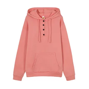 Close-up detail of coral pink hoodie featuring drawstring hood and four-button placket
